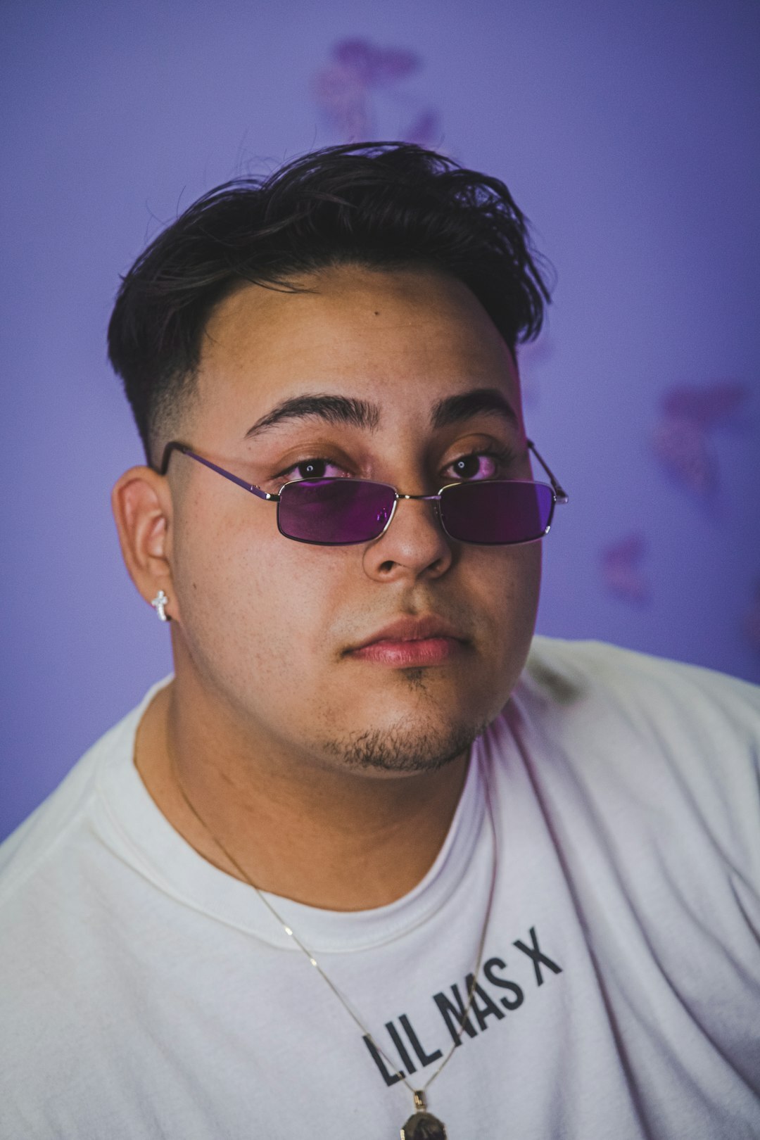 Studio portrait of a Latino man editor with glasses