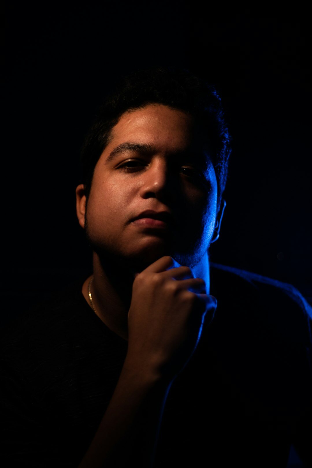 Studio portrait of a young Latino man writer